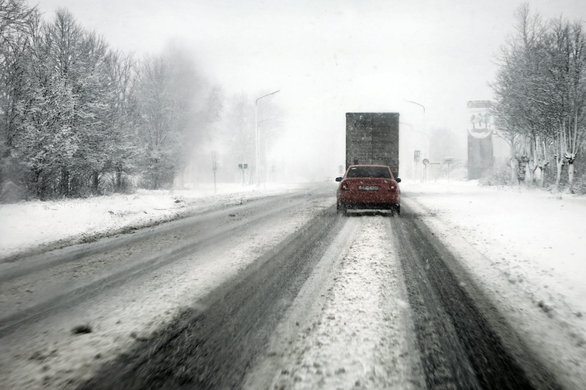 winter road traffic under blizzard conditions