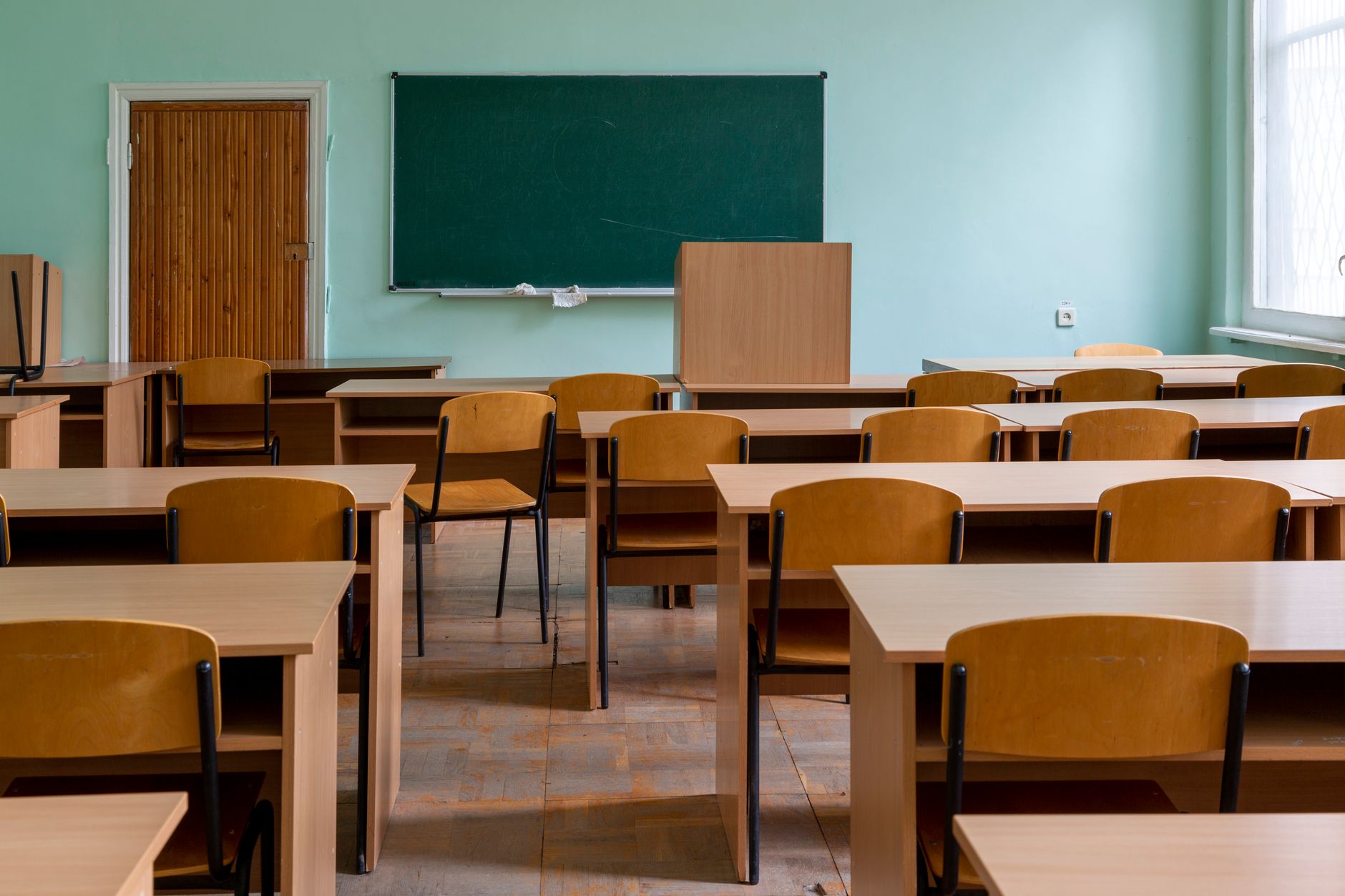 empty classroom with desks and chalkboard